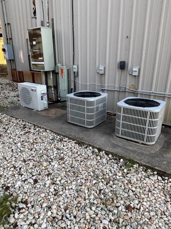 Two condensers, a mini-split and a Kohler generator installed on a light-commercial building